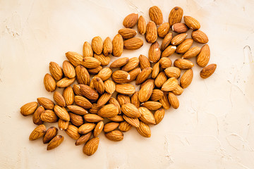 Almond kernels on beige table top view