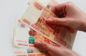 women's hands consider money large bills