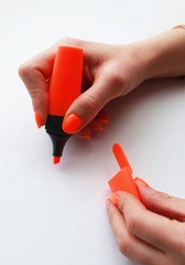 female hand with bright orange manicure