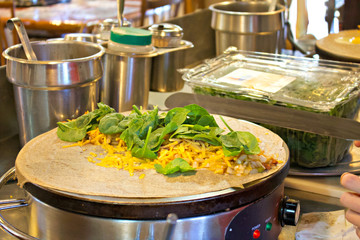 Cooking a spinach and cheese crepe