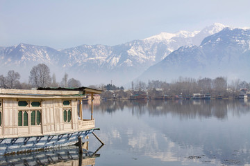Houseboat on Dal Lake in Srinagar, capital of Kashmir, looking towards the Himalayas. 