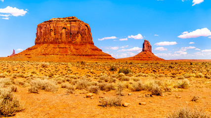 The sandstone formations of Merrick Butte and East Mitten Butte in the desert landscape of Monument Valley Navajo Tribal Park in southern Utah, United States