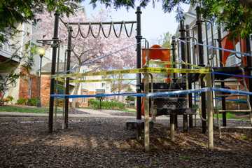 Fototapeta na wymiar Playground shutdown due to coronavirus outbreak during cherry blossom. Quarantine. Maryland. USA. March 26 2020. StayHome.