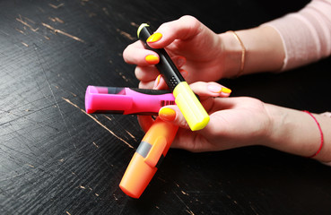 female hand with bright orange manicure