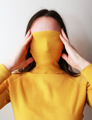 woman hides her face behind a cloth