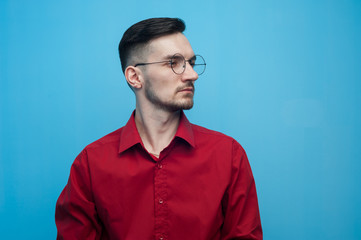 Young positive man in glasses and a red shirt