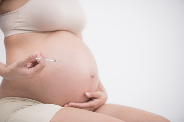 diabetes of pregnant. an asian pregnant is injecting Insulin pen. pregnant woman with syringe, isolated on white.  gestational diabetes. pregnancy health. gestational diabetes mellitus concept.