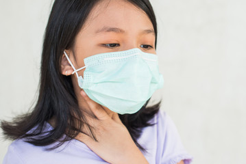 asia women wearing hygienic mask to prevent the virus PM2.5, Coronavirus, (2019-nCoV) asian little girl feeling unwell and coughing as symptom for cold or pneumonia,bronchitis. healthcare concept.