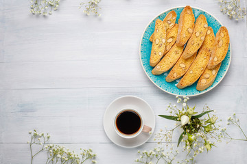 Obraz na płótnie Canvas Italian tuscan traditional cookies cantuccini with almonds ,a cup of coffee on light background,top view