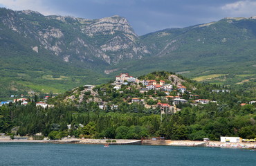 Fototapeta premium view of the small village in the green mountains near sea at summer