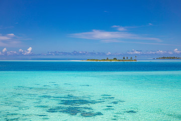 The drone photo with a wooden water villas seen from above and an amazing blue lagoon crystal clear water close to tropical lagoon. Amazing summer travel and vacation background. Dreamy beach scenery