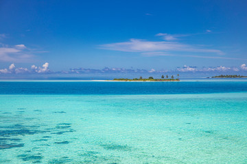The drone photo with a wooden water villas seen from above and an amazing blue lagoon crystal clear water close to tropical lagoon. Amazing summer travel and vacation background. Dreamy beach scenery
