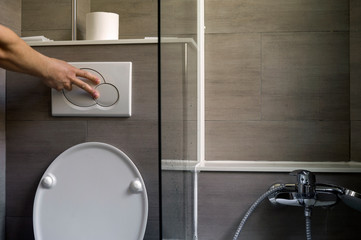 Hand flushing a toilet