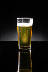 glass of beer on dark background