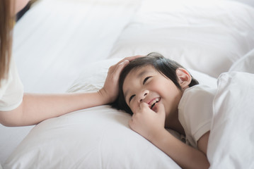 Asian child sleeping on white bed