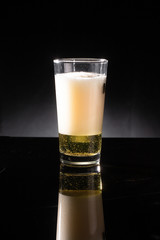 glass of beer on dark background