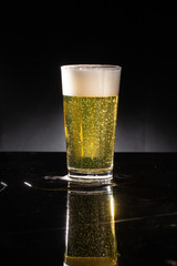 glass of beer on dark background