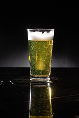 glass of beer on dark background