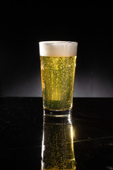 glass of beer on dark background
