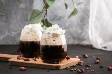 Ice coffee in a glass with wrapped cream
