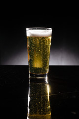 glass of beer on dark background