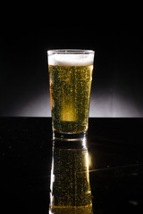 glass of beer on dark background