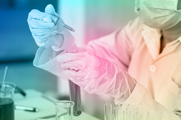 Asian Scientist Pipetting at a Biomedical Laboratory.Focused young life science professional...