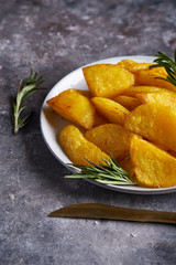 Fried potatoes country style. Barbecue potatoes. In a plate on a gray background Copy space