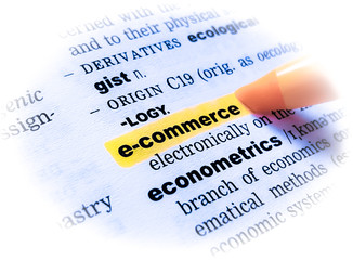 A close up of the word: e-COMMERCE in a dictionary, highlighted in yellow and showing part of its...