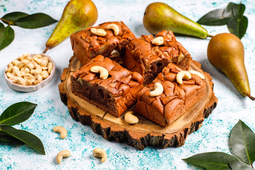 Homemade rustic chocolate cake with pear and cashew nuts,top view