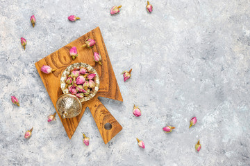 Assortment of dry tea in golden vintage mini plates.Tea types background:hibiscus,chamomile,mixed black tea,dry roses,butterfly pea tea