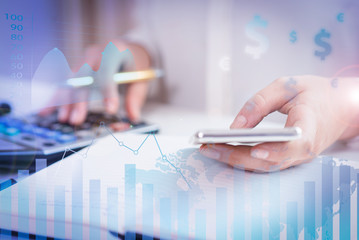 Person using digital devices with financial analysis graphs. Closeup of person using calculator and smartphone. Person calculating profit and browsing on device. Technology concept. Cropped view.