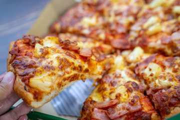 ham and pineapple on pizza in box