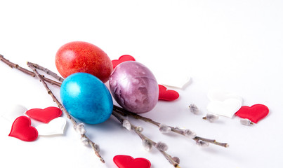 Easter eggs with hearts and willow branches on a white background