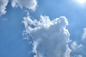 Blue sky blackground with flare cloud in the clear day