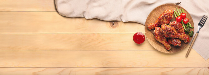 Cooked chicken drumsticks with vegetables and sauce on table with space for text