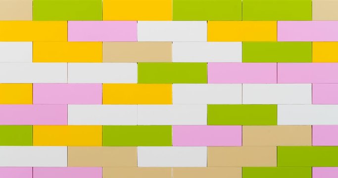 Colorful bricks making wall on white background