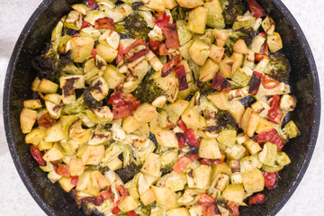 Vegetable stew, oven baked vegetables. Finely chopped and seasoned potatoes, bell peppers, zucchini and broccoli. Healthy food close-up