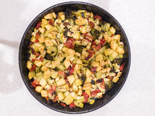 Vegetable stew, oven baked vegetables. Finely chopped and seasoned potatoes, bell peppers, zucchini and broccoli. Healthy food close-up