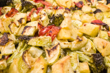 Vegetable stew, oven baked vegetables. Finely chopped and seasoned potatoes, bell peppers, zucchini and broccoli. Healthy food close-up