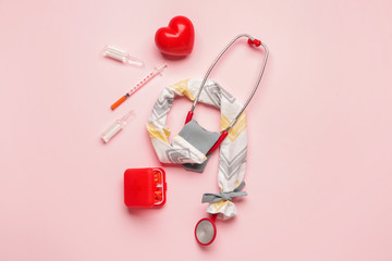 Stethoscope with cover, heart and medicines on color background