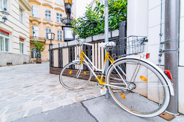 Fototapeta na wymiar old retro yellow bike at european city street