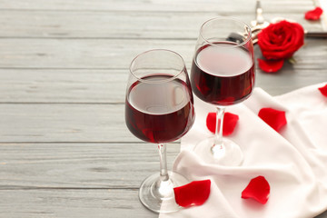 Glasses of wine on wooden background