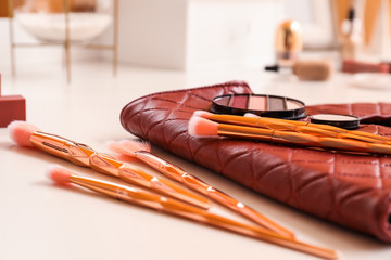 Set of brushes and decorative cosmetics on table of makeup artist
