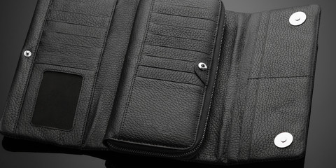 Fashionable leather men's wallet on a dark background