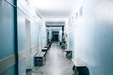 Empty hospital corridor with seats, bright and clean corridor