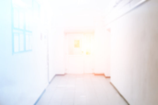 Empty hospital corridor with seats, bright and clean corridor, blur, unfocused photo