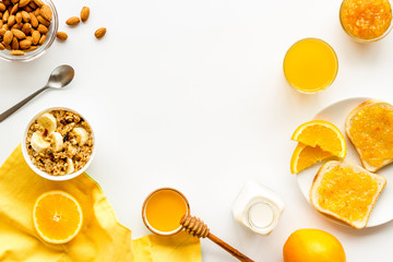 Vegetarian breakfast with granola and fruits on white background top-down frame copy space