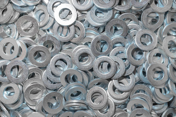 Washers for the bolt. Texture. Many washers for bolts and screws. Background for wallpaper. Shim. Spacer.