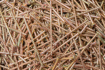 Wood screws. Texture. Background for wallpaper. A lot of long screws. View from above.
